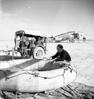 Western Desert, North Africa. c. 1943. Ground crew member of No. 459 (Hudson) Squadron RAAF, a Naval Co-operation Squadron, tests a self-inflating raft. Note the Lockheed Hudson aircraft in the background.