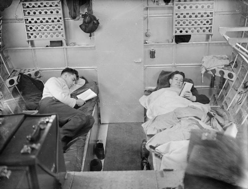 Off-duty aircrew relax
                    in the aft sleeping compartment of a Sunderland of
                    No 10 Squadron RAAF, July 1940.