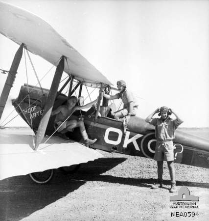 Sicily, Italy. c. 1943. Pilots of the Desert Harassers No. 450 (Kittyhawk) Squadron RAAF, utilise a captured Caproni aircraft for training purposes.