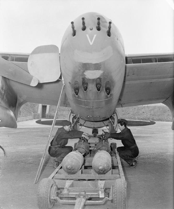 Armourers prepare to load four 500-lb MC bombs into the bomb-bay of De Havilland Mosquito FB Mark VI, MM403 'SB-V', of No. 464 Squadron RAAF at Hunsdon, Hertfordshire.
